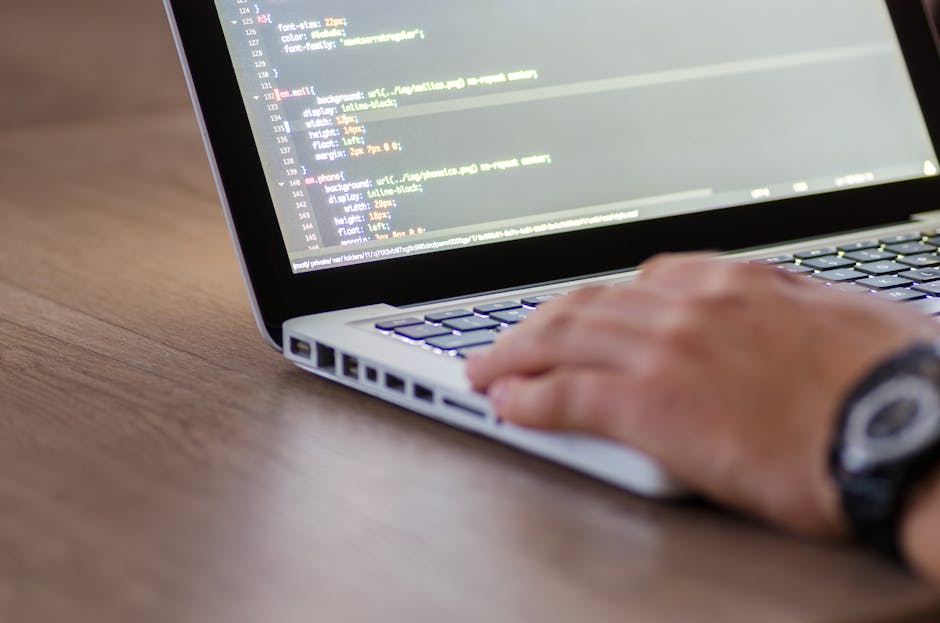 A close-up view of a computer screen displaying lines of HTML and CSS code with syntax highlighting in various colors such as green, yellow, orange, and white. The code includes navigation elements li